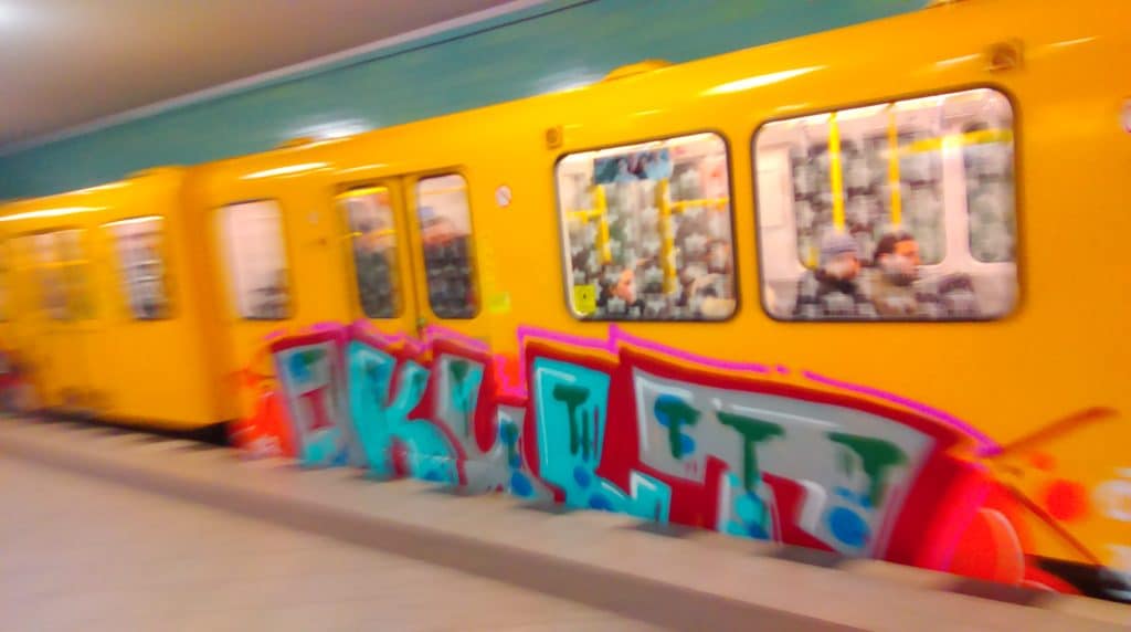The OKULT Graffiti leaves with the subway. Letters in Blue and grey Fill Ins and red Outlines.
