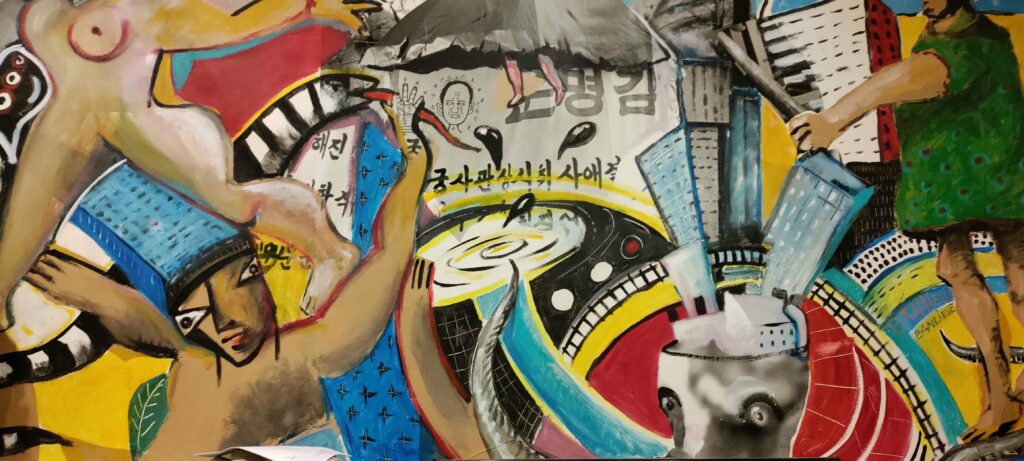 Œuvre d'art polychrome d'Alain Campos, artiste de street art urbain décédé et cofondateur du collectif d'art urbain Banlieue-Banlieue en France. Décoration murale dans le squat Aubergine3000 à Malakoff, dans la banlieue sud de Paris,